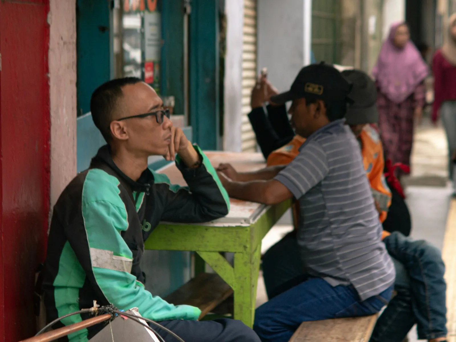 Dua orang berdiskusi di warung tepi jalan